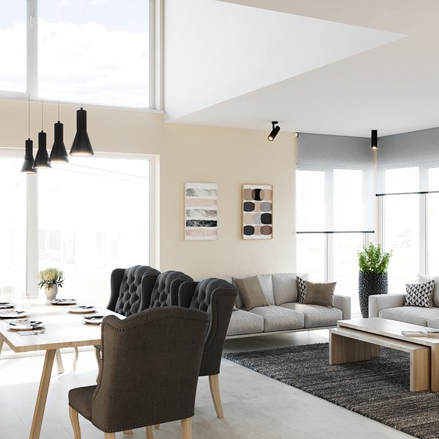 ein offenes Wohnzimmer eines KAMPA Hauses mit großen Fenstern und einer hellen gemütlich, modernen Einrichtung