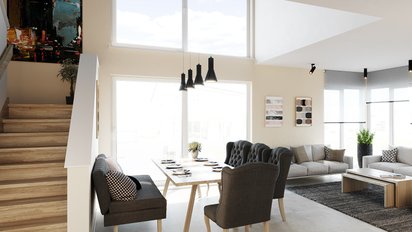ein offenes Wohnzimmer eines KAMPA Hauses mit großen Fenstern und einer hellen gemütlich, modernen Einrichtung