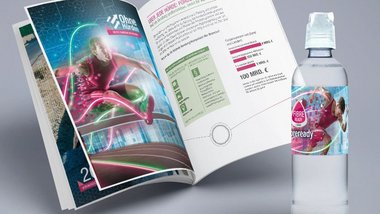 Aufgeschlagene Broschüre und eine Wasserflasche als GiveAway mit dem KeyVisual des Projekts DigiNetz
